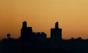 silhouette of Ludlow Co-op Elevator location with sunset in the background